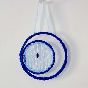Boho dream catcher made with light and dark blue yarn